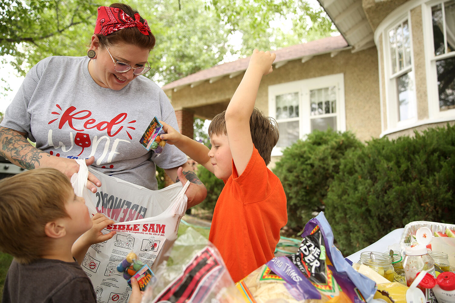 Owen Brown, 4, and his brother Elliot, 7, dig through their new bag of fireworks
